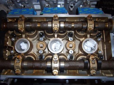 1991 Ford Taurus - Close-up view of an engine's valve train, showing camshafts and valve openings.