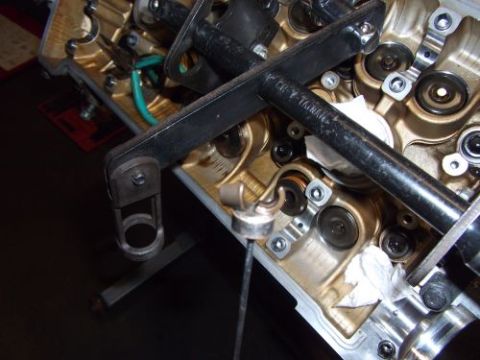 1991 Ford Taurus - Tool is positioned on the engine's valve train, showing internal components.