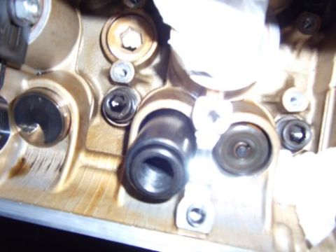 1991 Ford Taurus - Close-up view of engine valve train components, showing oil residue and fasteners.