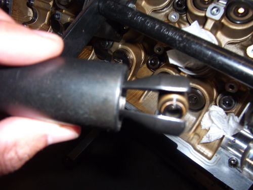 Engine valve spring compressor tool over engine internals