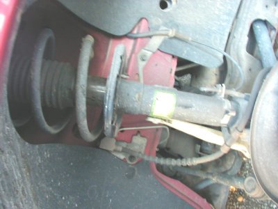 1997 Ford Taurus - This image shows a close-up view of a vehicle's front suspension system, including the shock absorber and coil spring assembly.