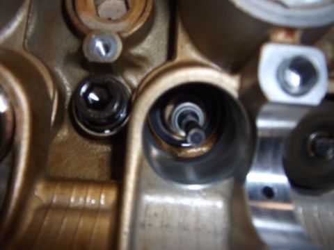 1991 Ford Taurus - Engine cylinder head detail, focusing on the spark plug well and adjacent parts.