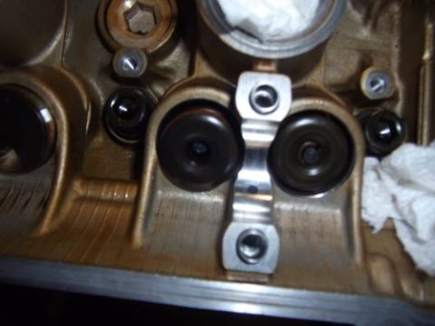 1991 Ford Taurus - A close-up view of an engine's cylinder head, showing the valves and associated mechanical components.