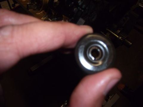 1991 Ford Taurus - A close-up view of a metal automotive part being held, with the Supermotors logo visible at the bottom.