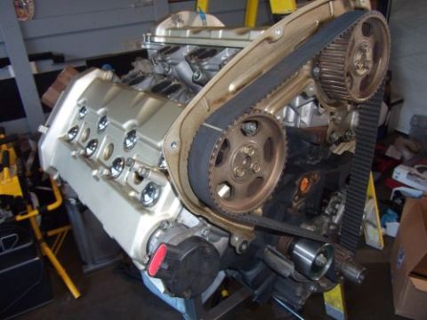 1991 Ford Taurus - Engine with timing belt and pulleys, mounted on a stand. Supermotors.net logo visible.