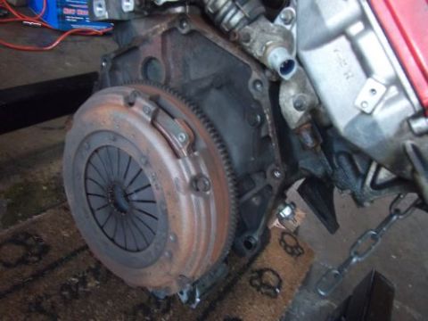 1991 Ford Taurus - Close-up view of an engine and clutch assembly, showing a rusty flywheel and transmission components.