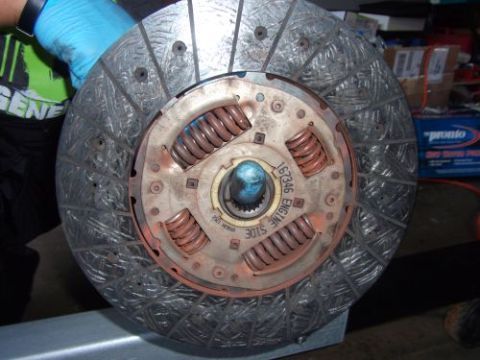 1991 Ford Taurus - A close-up view of a vehicle clutch disc, showing its internal spring mechanism and friction material.