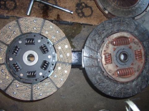 1991 Ford Taurus - Comparison of a new clutch disc next to a worn one.