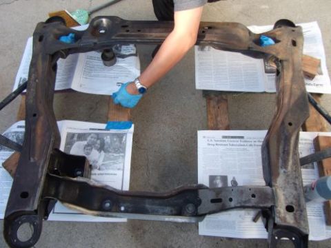 1991 Ford Taurus - Cleaning a car subframe, possibly for an engine swap. Supermotors.net logo is present.