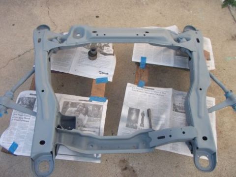 1991 Ford Taurus - A car subframe, likely for an engine swap, is shown after being painted gray.