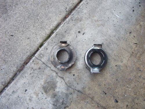 Two metal headlight retaining rings on concrete