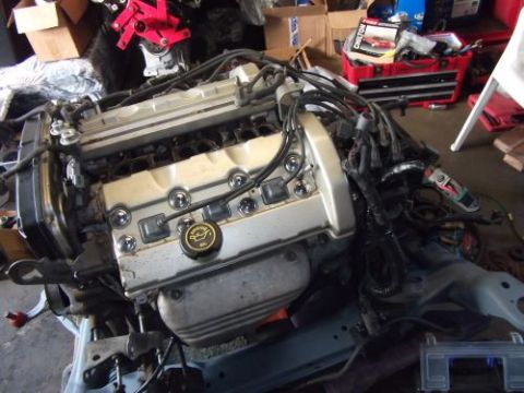 1991 Ford Taurus - Engine assembly with silver valve covers and visible wiring harness, likely for an engine swap.