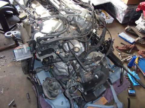 1991 Ford Taurus - Engine assembly with wiring harness and power steering rack, likely removed for repair or swap.