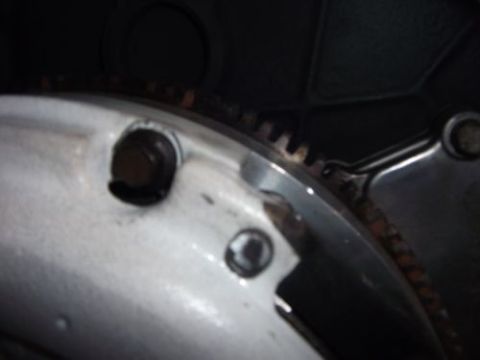 1991 Ford Taurus - Detail of an engine component, possibly a flywheel or flexplate, showing gear teeth and mounting bolts.