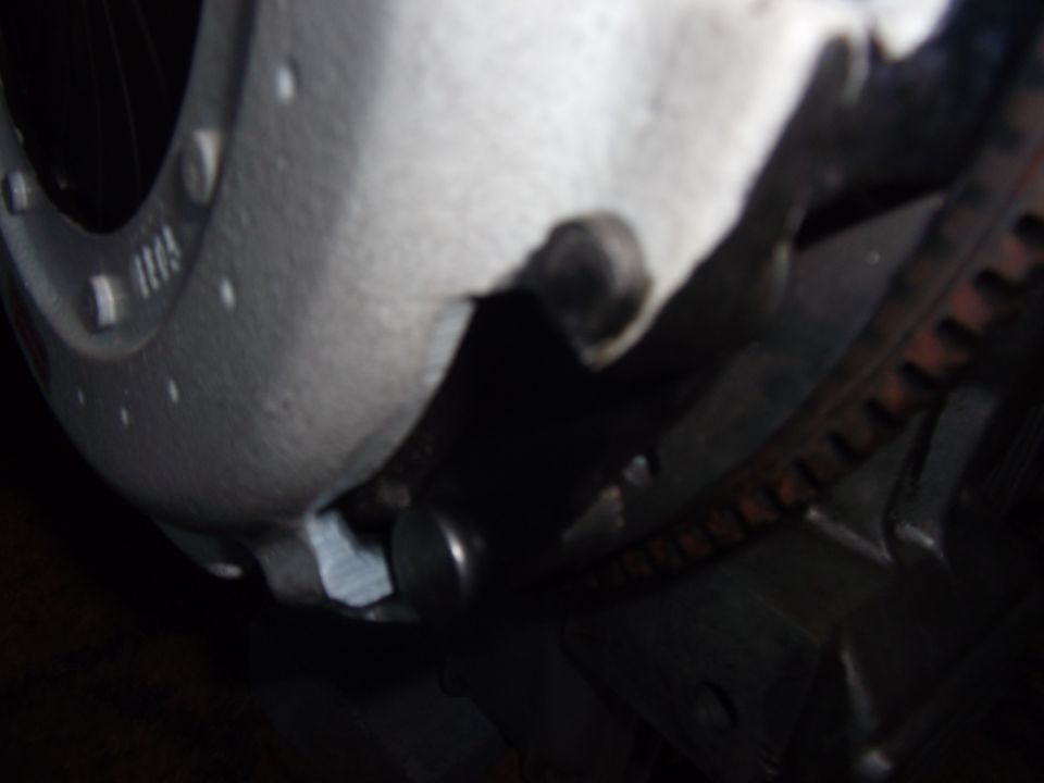Close-up of a metal engine component with a ribbed belt