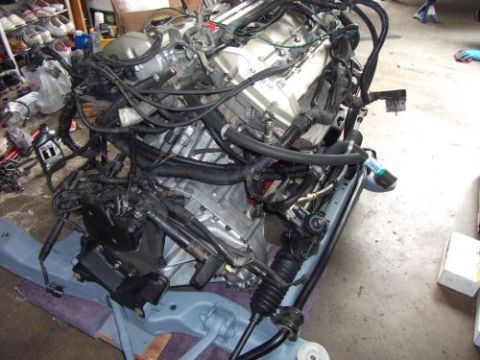 1991 Ford Taurus - Engine assembly with complex wiring and plumbing, likely removed for repair or modification.