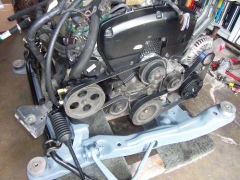 1991 Ford Taurus - Close-up of an engine assembly, possibly for a swap, with various components visible.
