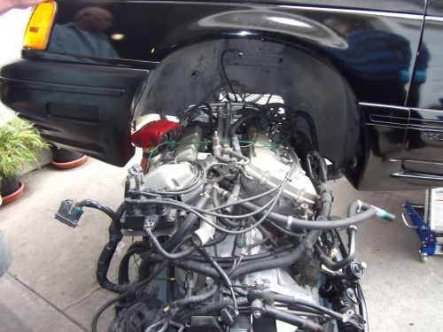 Black 1991 Ford Taurus fender with exposed engine and wiring