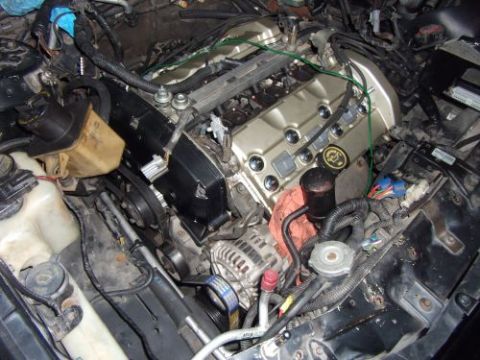 1991 Ford Taurus - Engine bay details, including gold valve covers and alternator. SuperMotors logo is visible.