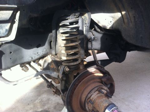 1991 Ford Bronco - This image shows the underside of a vehicle, focusing on the suspension and braking system components.
