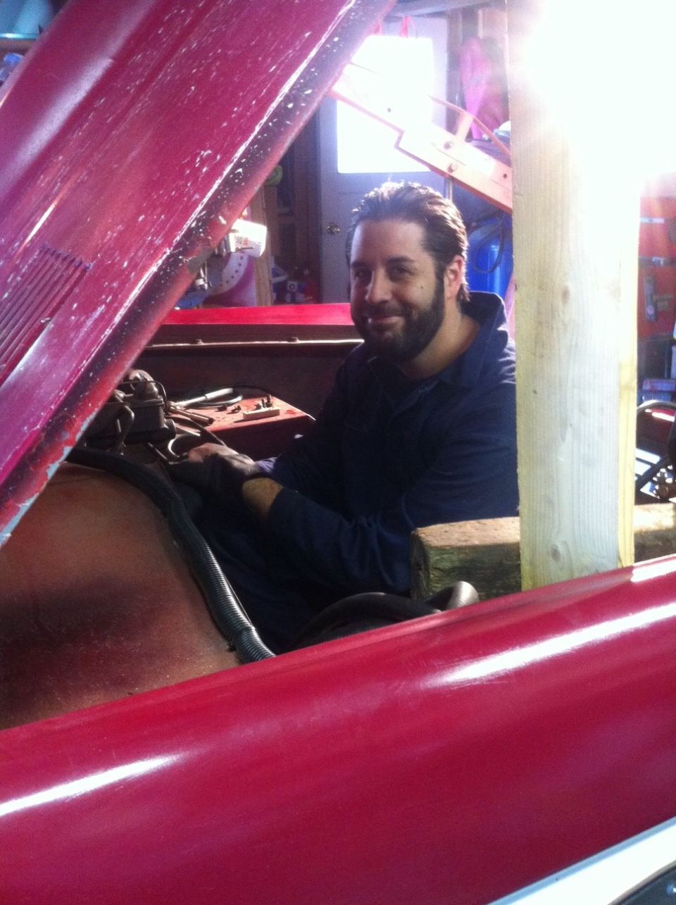 1968 Ford Bronco engine bay with man working