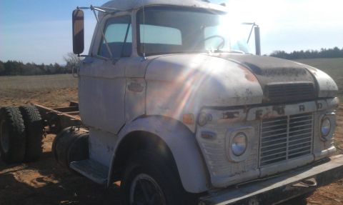 1973 Ford F-100 - This 1973 Ford F-100 cab and chassis is seen from the front-right in a field.