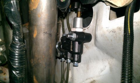 1992 Ford Ranger - Close-up of a black brake proportioning valve, possibly a "Poo8" brand, mounted in a vehicle's engine bay.