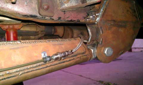 1992 Ford Ranger - Custom suspension modification showing a brake line connected to a fabricated metal component.