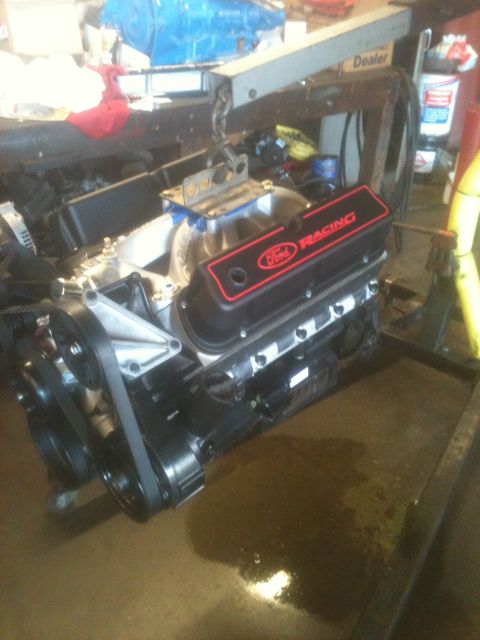 1993 Ford Bronco - A Ford Racing engine, likely a V8, is mounted on an engine stand, ready for installation or work.