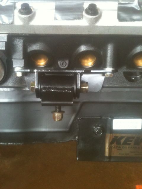 1993 Ford Bronco - Close-up view of an engine block with a black mounting bracket. A label on the lower right reads KEV.