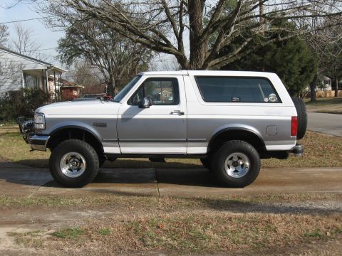 1994 Ford Bronco - This 1994 Ford Bronco is shown from the side, a two-tone paint scheme and a spare tire mounted on the rear door.