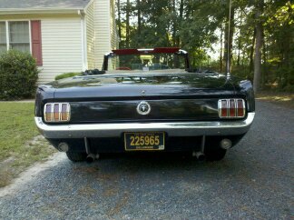 1965 Ford Mustang - Rear view of a black 1965 Ford Mustang convertible with a Delaware license plate.