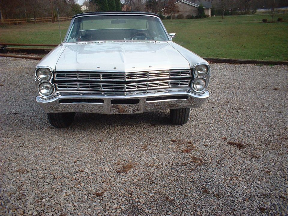 White 1967 Ford Galaxie convertible, front view, parked on gravel