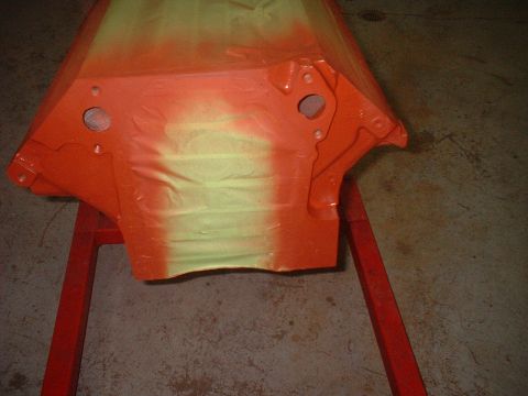 1969 Mercury Cyclone - Engine block undergoing a two-tone spray paint job on a red stand.
