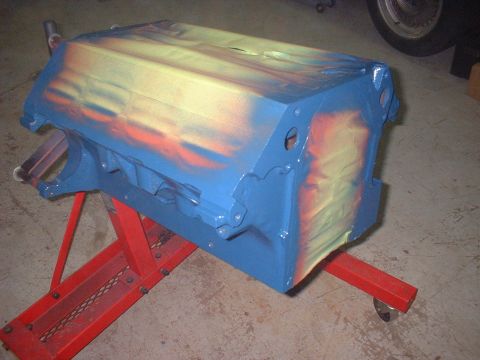 1969 Mercury Cyclone - Engine block painted blue with orange and yellow flame accents sits on a red engine stand.