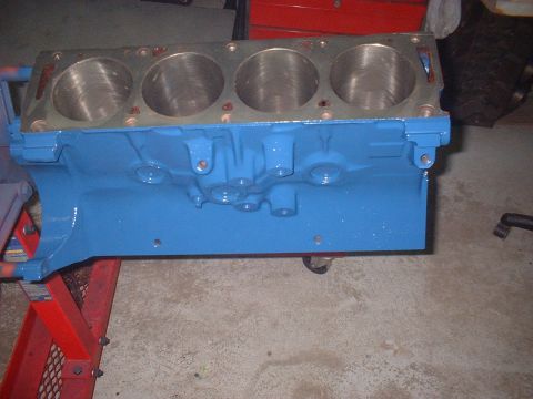 1969 Mercury Cyclone - A blue engine block is shown on a stand, likely in a garage or workshop setting.
