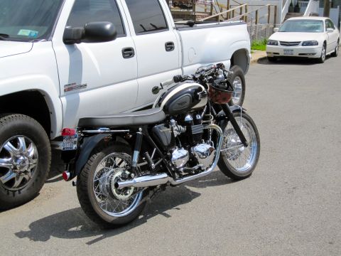 1992 Ford Bronco - Motorcycle parked beside a white pickup truck and a white sedan on a sunny day.