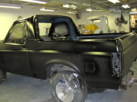 1992 Ford Bronco - This Ford Bronco is undergoing body work in a shop, with another vehicle visible in the background.