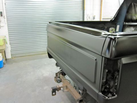 1992 Ford Bronco - The rear of a 1992 Ford Bronco is shown in a garage, undergoing preparation for paint.