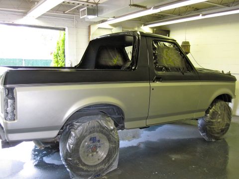 1992 Ford Bronco - This 1992 Ford Bronco is undergoing a paint job, with its wheels covered for protection.
