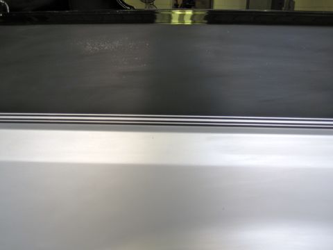 1992 Ford Bronco - A close-up view of the rear quarter panel of a silver SUV, black trim and a Supermotors.net watermark.