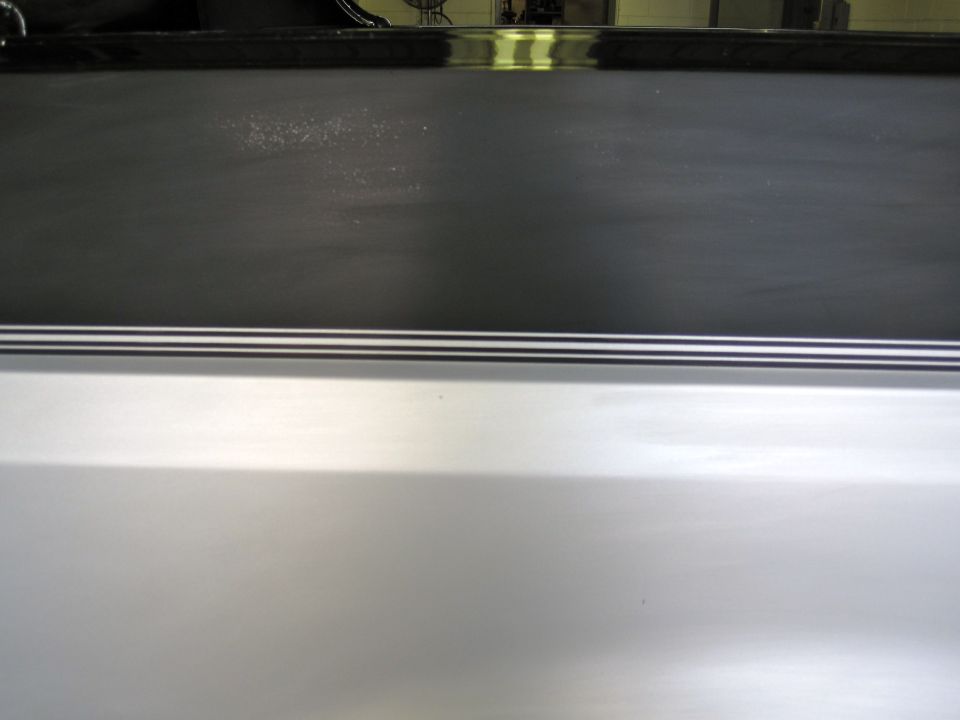 Silver SUV rear quarter panel with black trim and Supermotors.net watermark