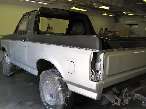 1992 Ford Bronco - 1992 Ford Bronco undergoing bodywork in a workshop, rear quarter view.