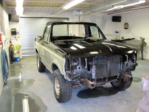 1992 Ford Bronco - This 1992 Ford Bronco is undergoing repairs in a garage, with its front end removed.
