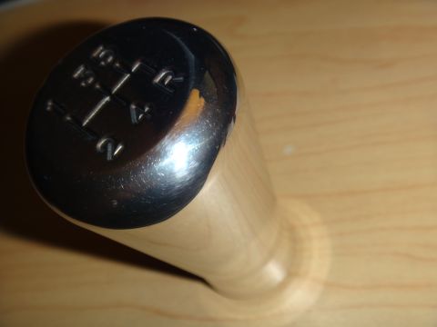 1995 Ford Taurus - Close-up of a chrome and wood shift knob displaying a 5-speed manual gear pattern.
