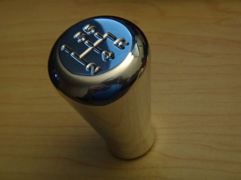 1995 Ford Taurus - A close-up of a chrome shift knob displaying a 5-speed manual gear pattern.