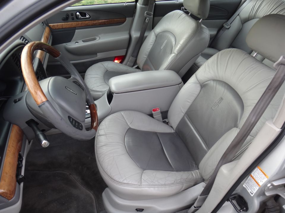 Interior of a 2000 Lincoln Continental showing leather seats and wood trim