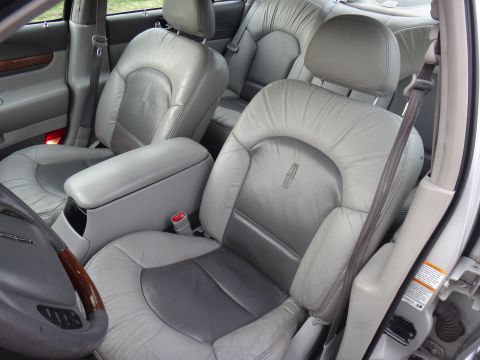 2000 Lincoln Continental - Interior view of a 2000 Lincoln Continental, showing front and rear leather seats.