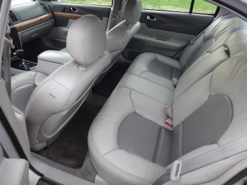 2000 Lincoln Continental - The interior of a car is shown, focusing on the rear seating area and part of the front passenger seat.