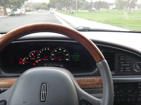 2000 Lincoln Continental - The interior of a 2000 Lincoln Continental, showing the dashboard, steering wheel, and instrument cluster.